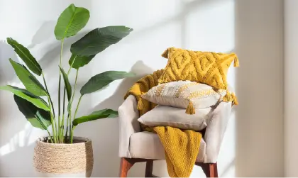 Image of grey chair with yellow pillows on it